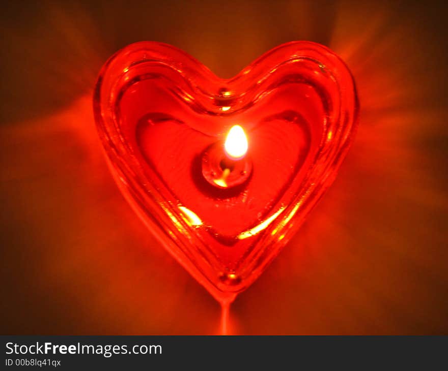 Burning heart. Burning candle in the form of the heart.