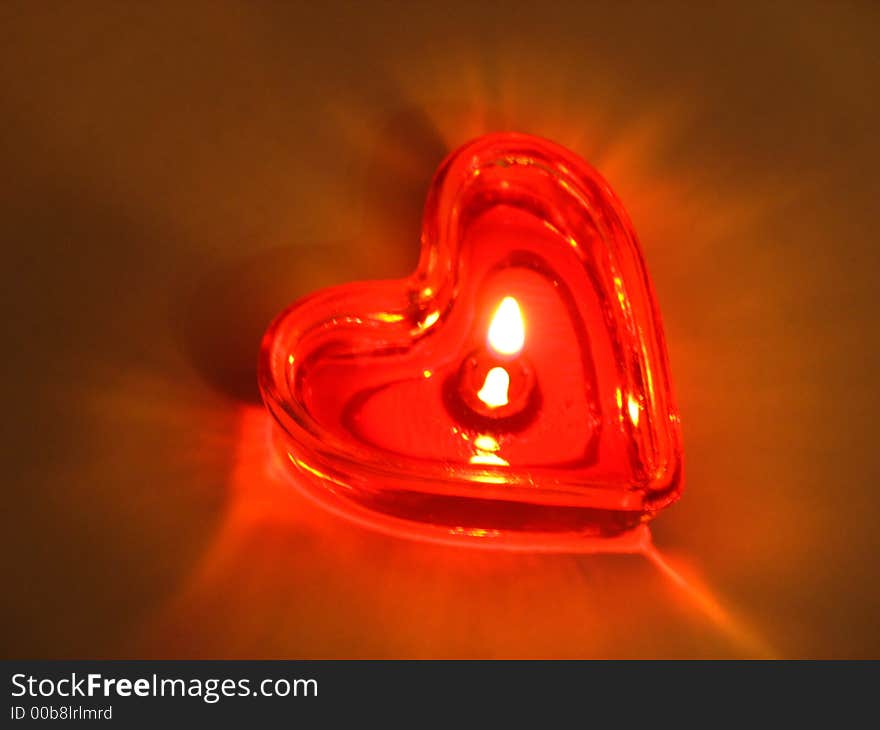 Burning heart. Burning candle in the form of the heart.