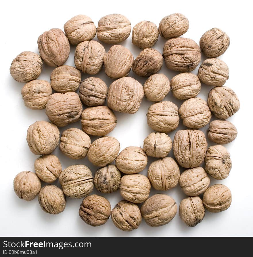 Walnuts background with the free place in the center of image for inserting smth