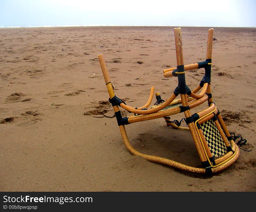 Upturned chair lying on the beach. Upturned chair lying on the beach.