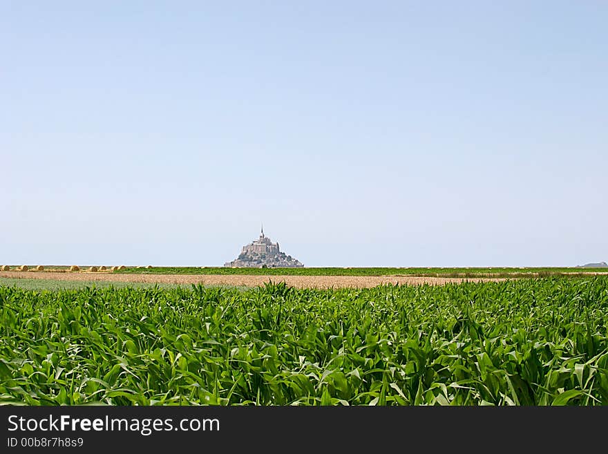 Mont Saint-Michel, a tourist attraction in Normandy (France). An abbey is built upon a rock in the ocean. During ebb-tide it is possible to drive or to walk to the rock. Mont Saint-Michel, a tourist attraction in Normandy (France). An abbey is built upon a rock in the ocean. During ebb-tide it is possible to drive or to walk to the rock.