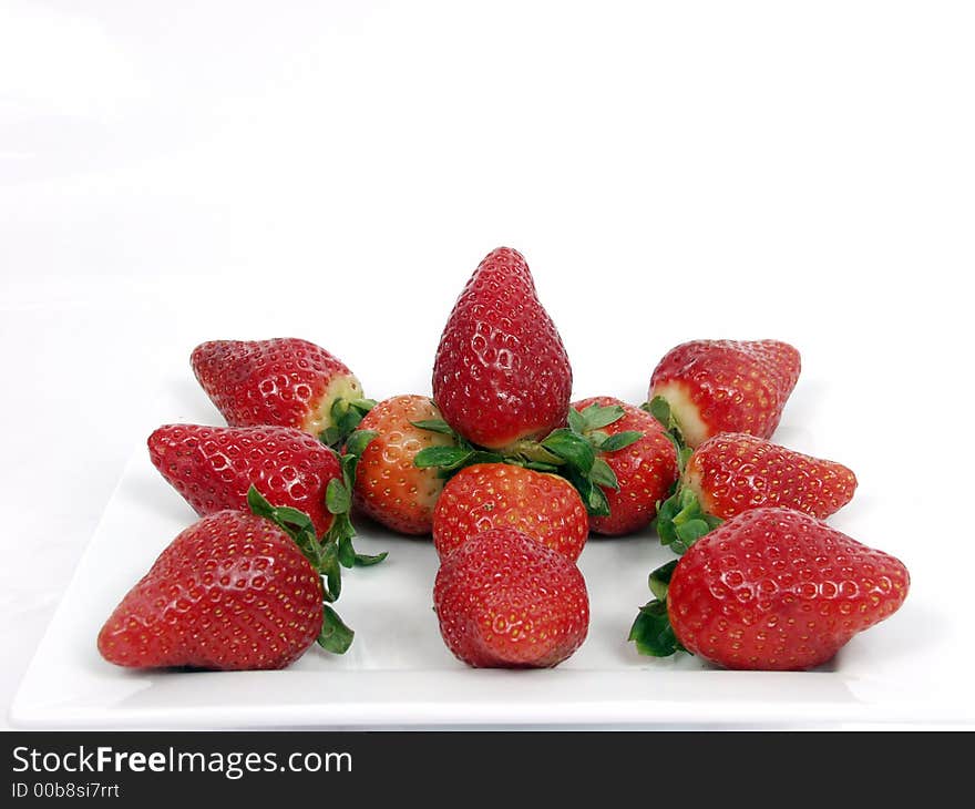 Some strawberry on a platter in white background