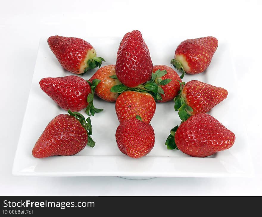 Some strawberryon a platter  on white background