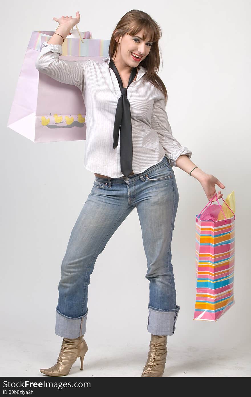 Cute Girl with shopping bags over grey background