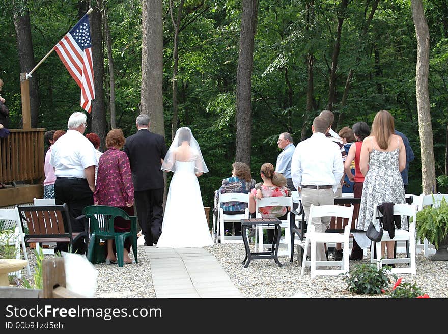 A father walking a daughter down the aisle. A father walking a daughter down the aisle.