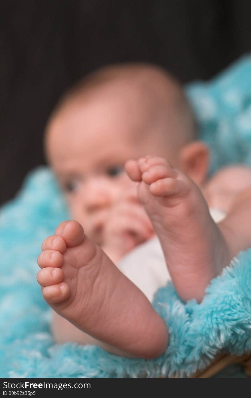 Image of baby boy nestled in a basket. Image of baby boy nestled in a basket