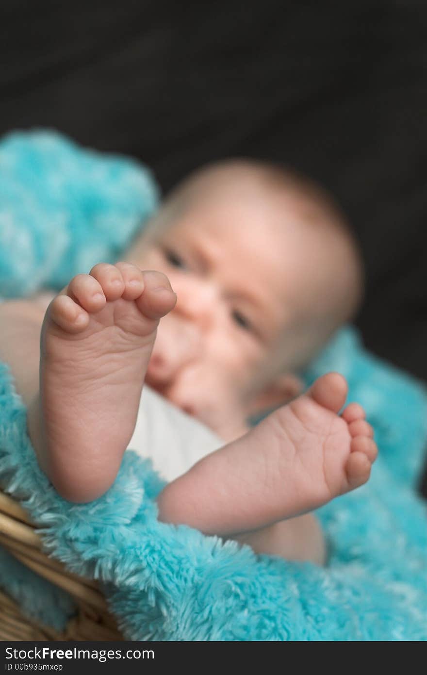 Image of a beautiful baby boy nestled in a blanket-lined basket. Image of a beautiful baby boy nestled in a blanket-lined basket