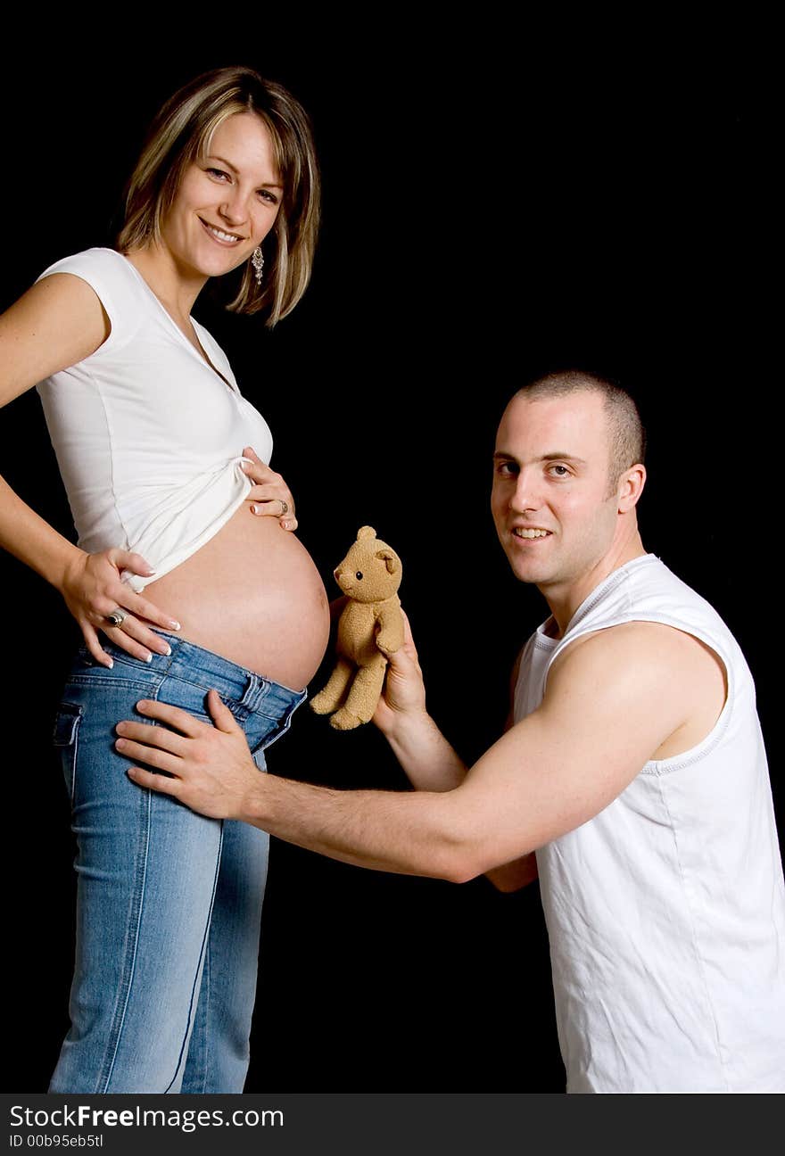 Couple with their teddy bear looking at camera. Couple with their teddy bear looking at camera