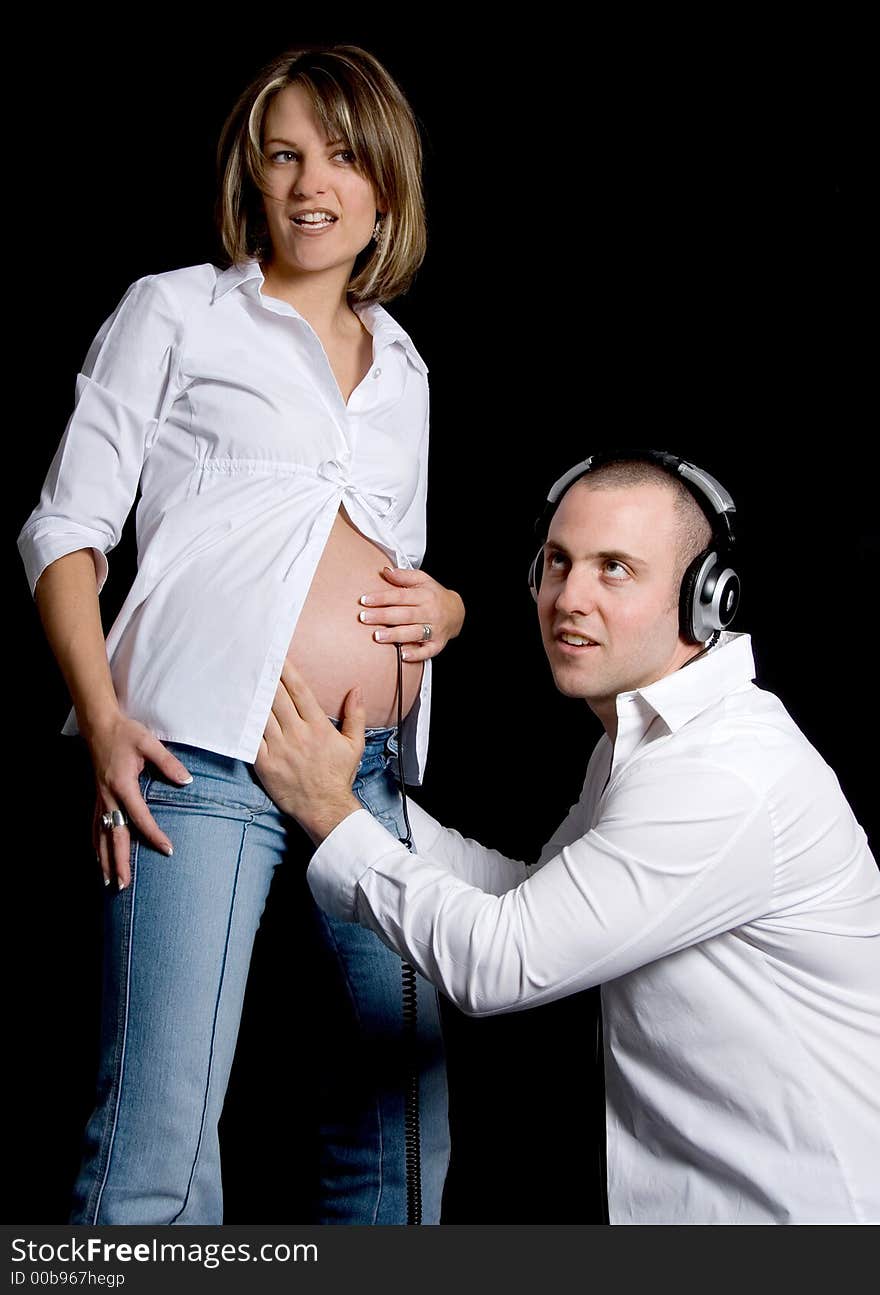 Young future parents listening to the womb