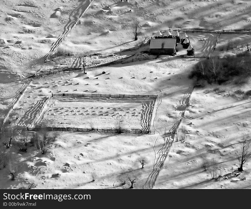 Small farm into the country in wintertime.