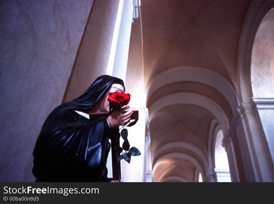 Statue of Virgin Mary with rose