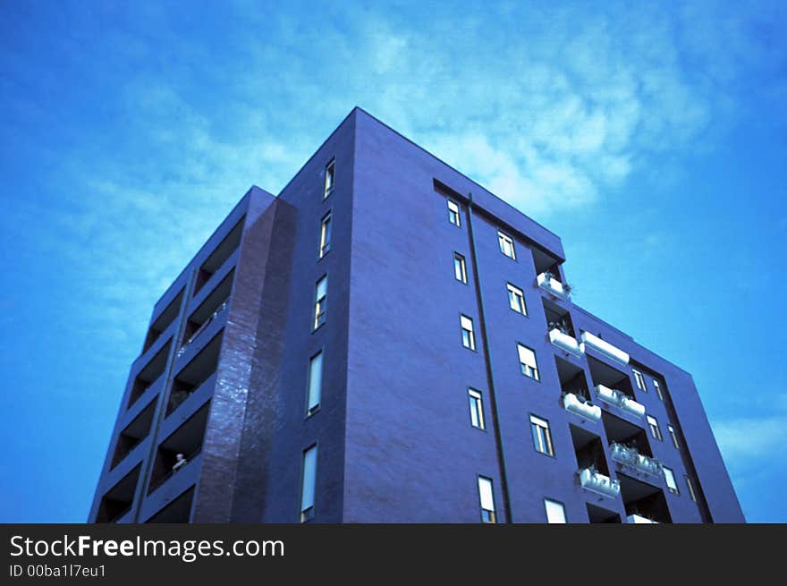 Purple building and cloudy sky. Purple building and cloudy sky