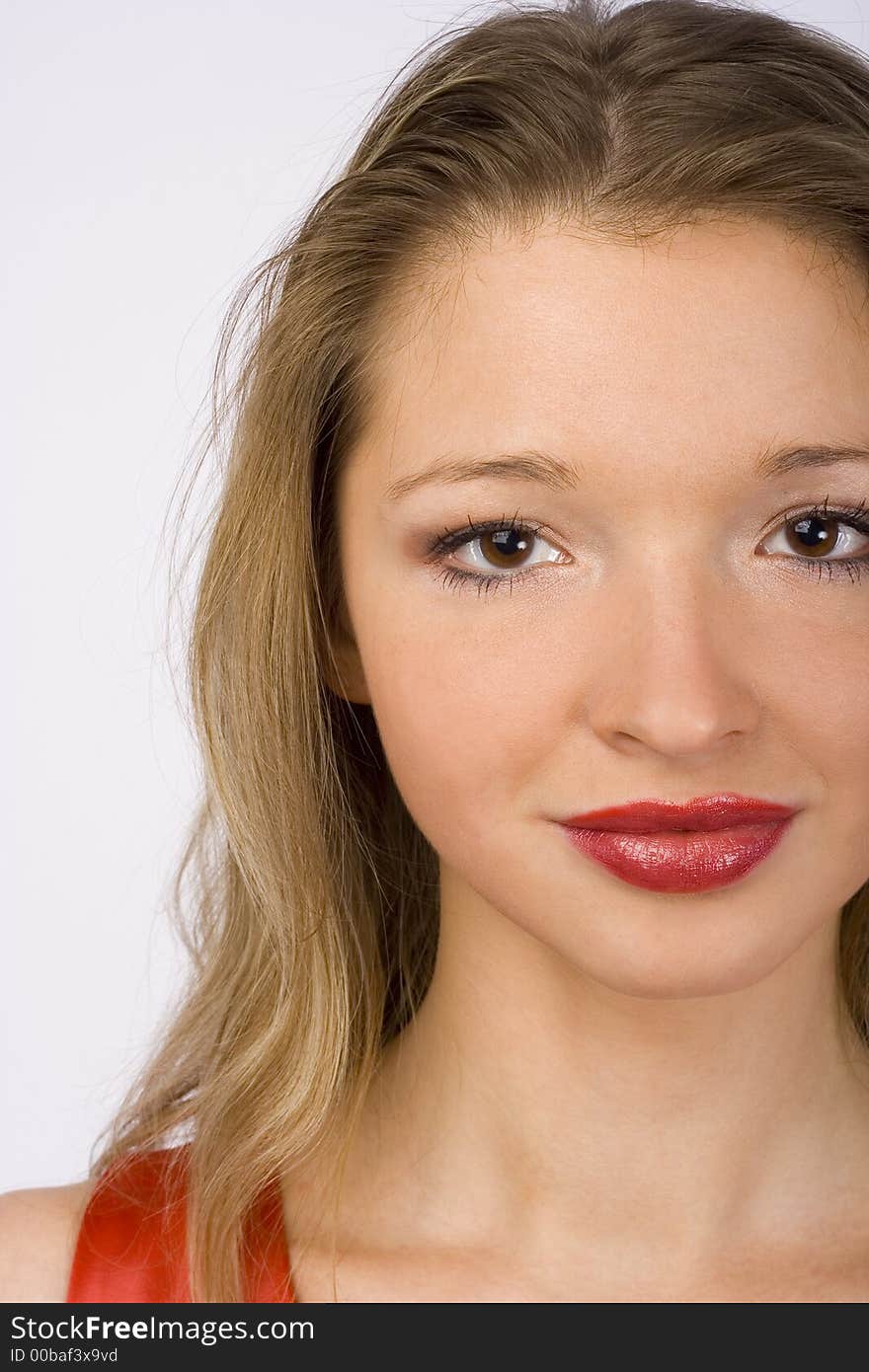 Closeup of female face. Red lipstick and red dress. Closeup of female face. Red lipstick and red dress.