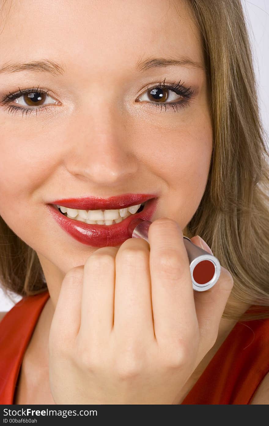 Face of young woman putting red lipstick. Face of young woman putting red lipstick