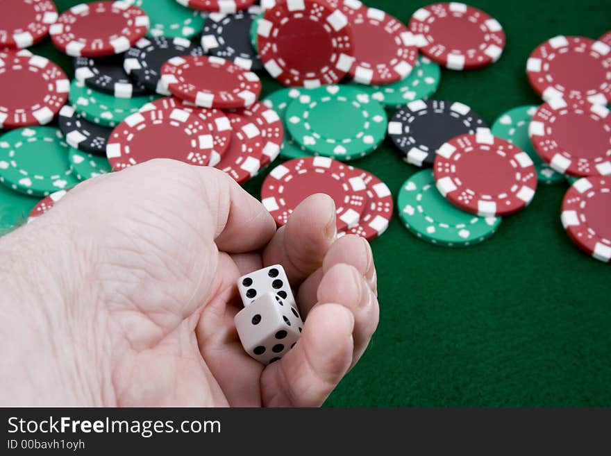 Close up of a hand getting ready to roll a pair of die. Close up of a hand getting ready to roll a pair of die