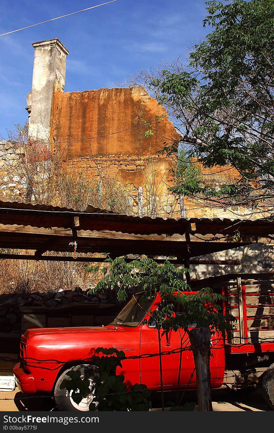 Typical colonial house semi abandoned with red truck in the town of Alamos, in the northern state of Sonora, Mexico, Latin America