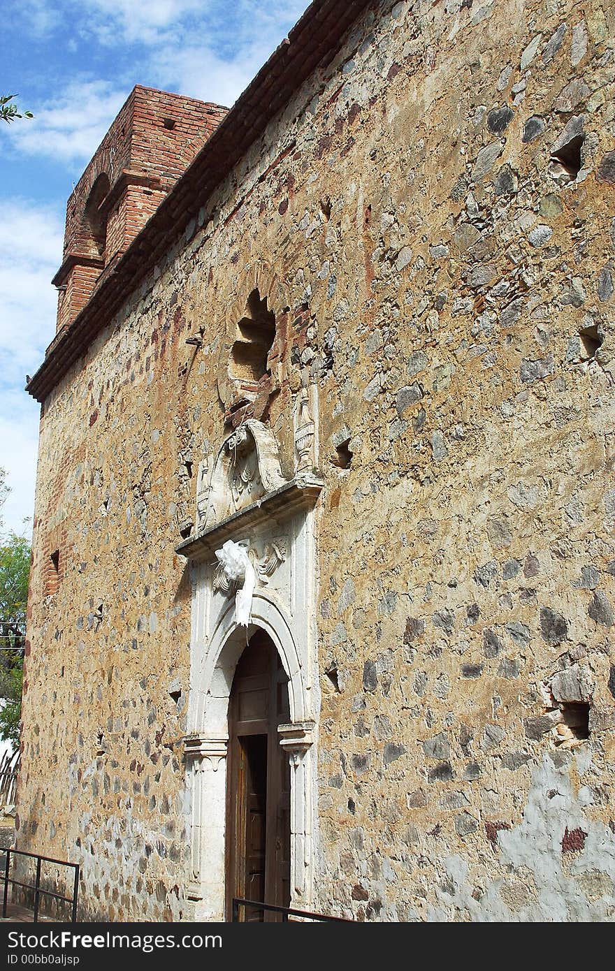 Stoned wall with tower of a chapel in the town of Alamos, in the northern state of Sonora, Mexico, Latin America