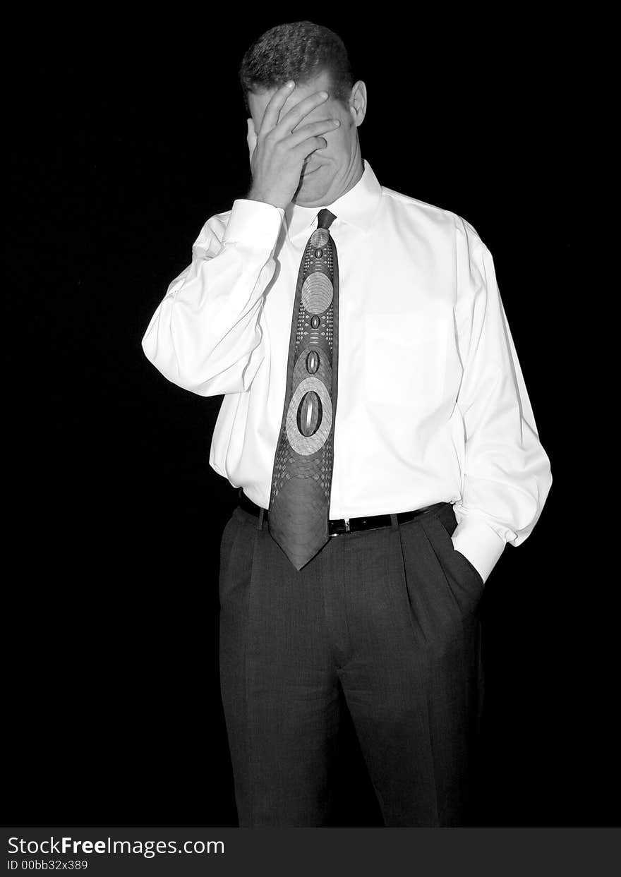 Man in a white shirt and tie looks upset. Man in a white shirt and tie looks upset.