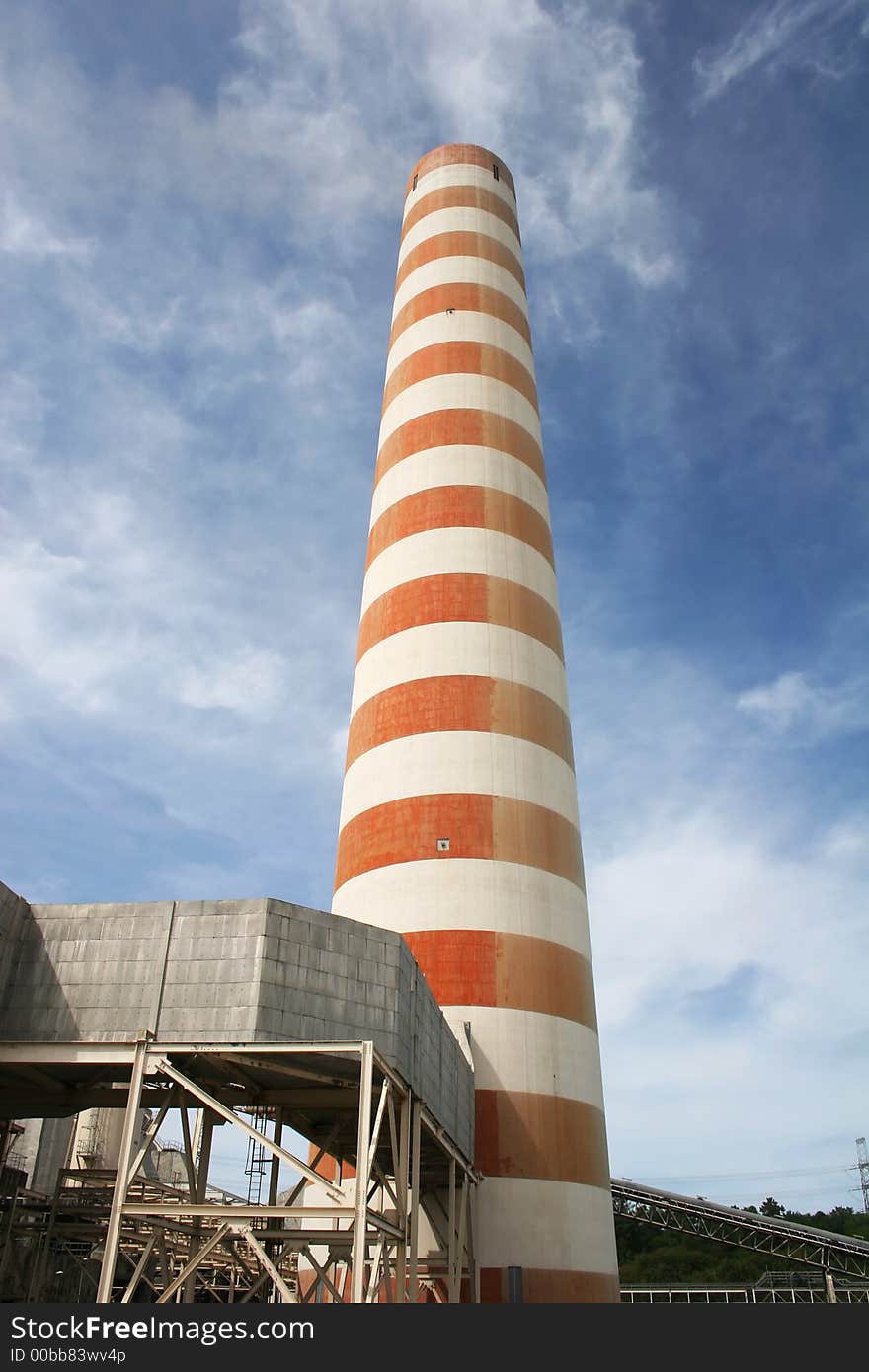 Striped industrial chimney against the blue sky. Striped industrial chimney against the blue sky