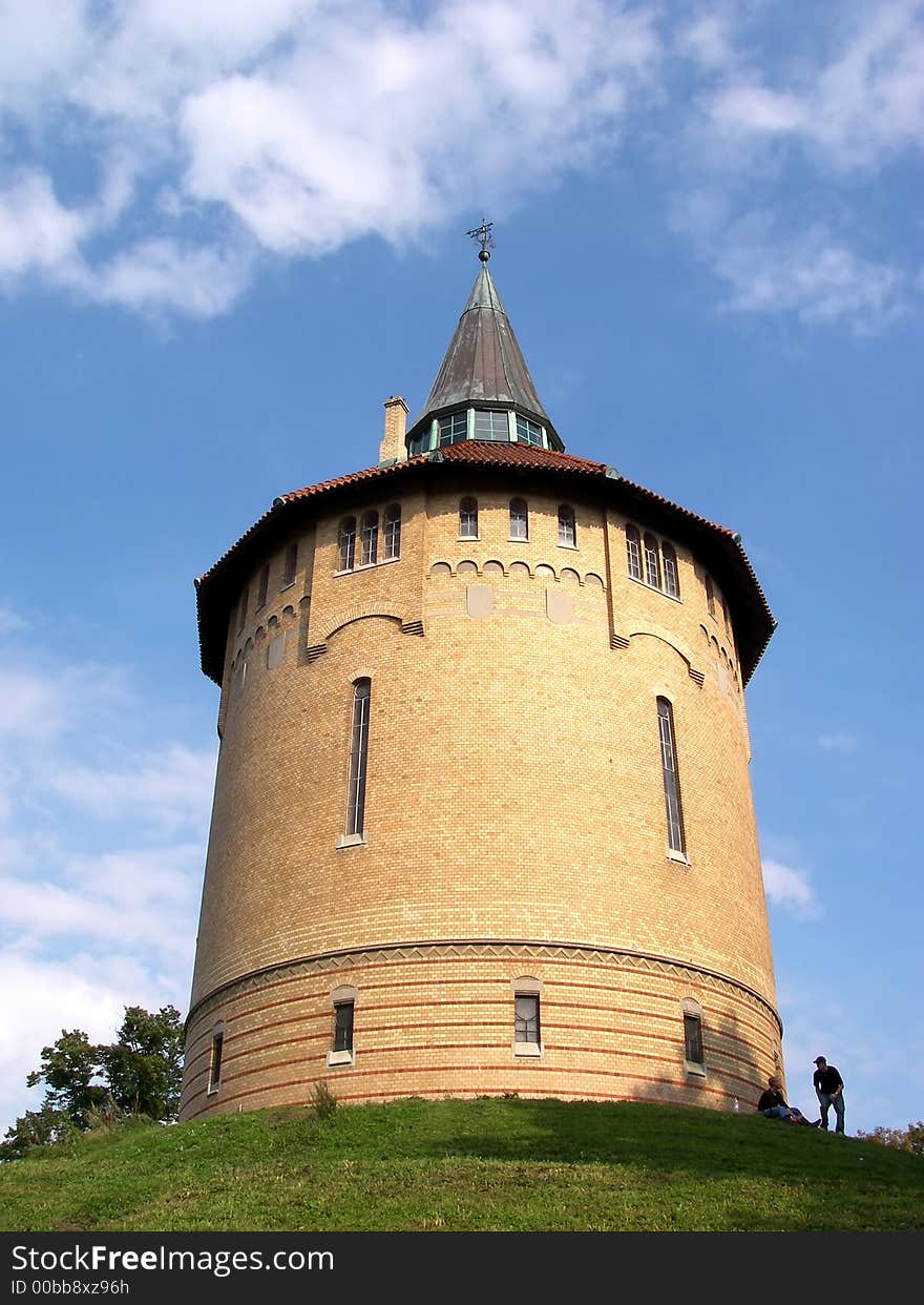 Portrait of watertower on green hill in summertime. Portrait of watertower on green hill in summertime