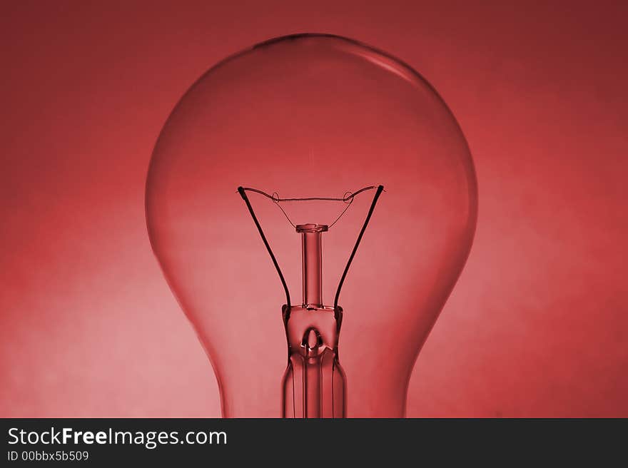 Light bulb silhouette over a coloured red background