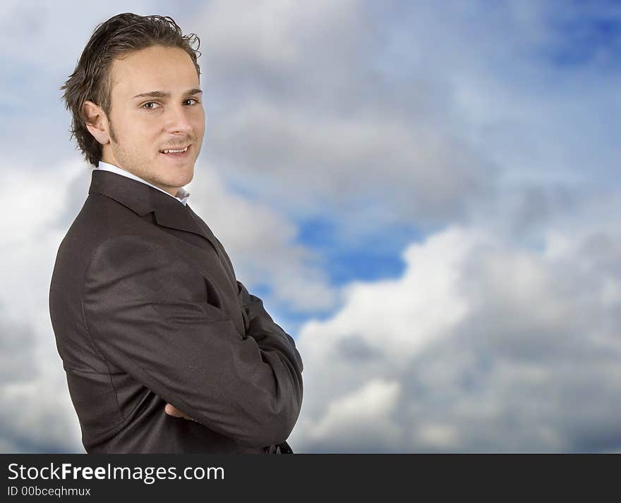 Businessman posing against the sky in sleek outfit