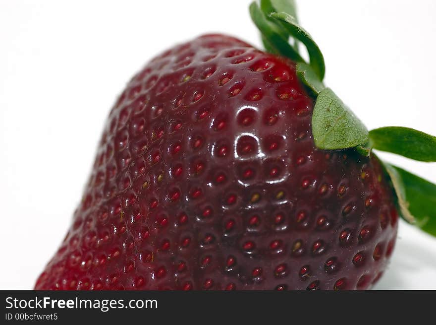 A closeup shot of a strawberry isolated against a white background