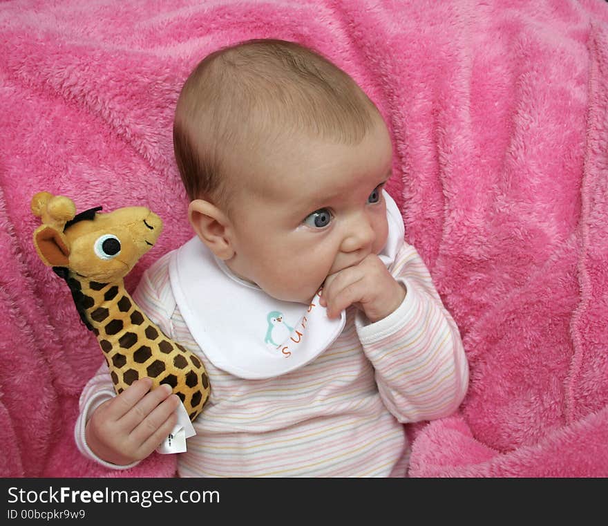 A baby on a pink blanket. A baby on a pink blanket