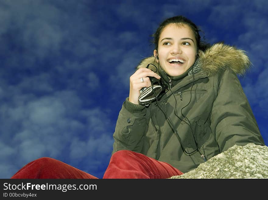 Young smiling girl listening mp3 player. Young smiling girl listening mp3 player