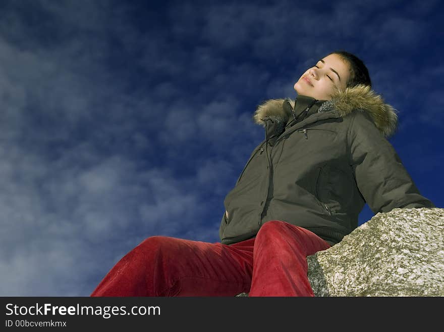 Relaxing girl on maountain on blue sky