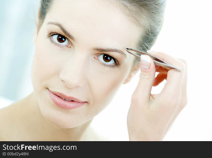 Portrait of Beautiful brunette woman doing daily morning routines (the make up series 2). Portrait of Beautiful brunette woman doing daily morning routines (the make up series 2)