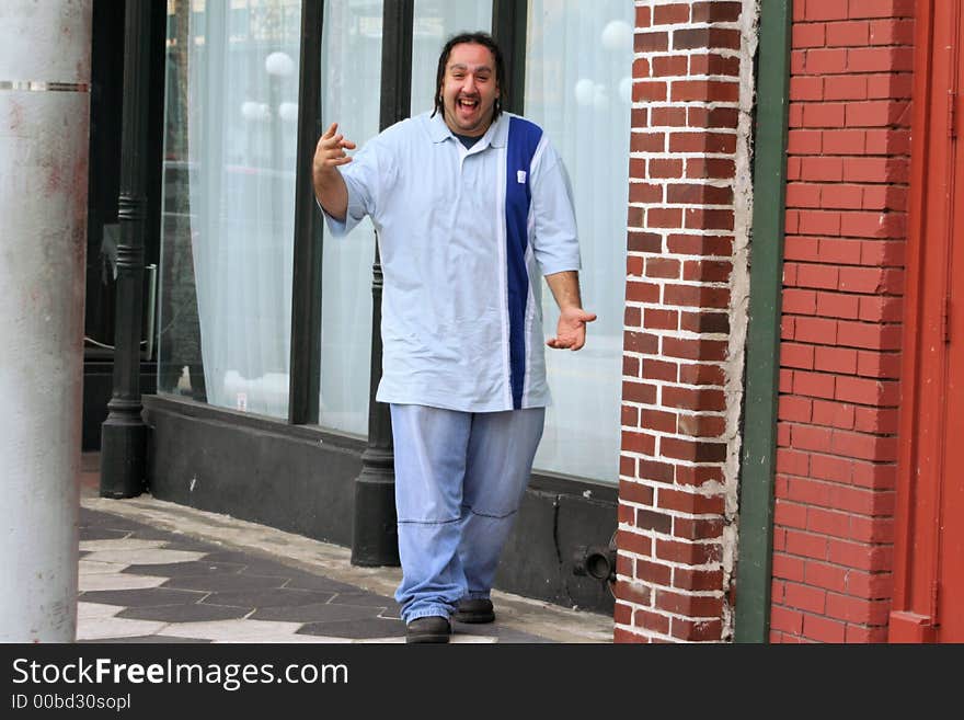 Photo of a young man walking down the sidewalk, happy to see you. Photo of a young man walking down the sidewalk, happy to see you