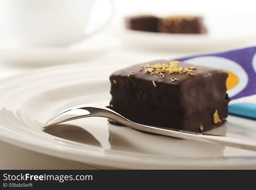 Chocolate cake and spoon on the coffee table