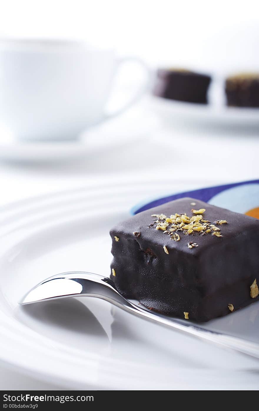 Chocolate cake,coffee and spoon on the coffee table.