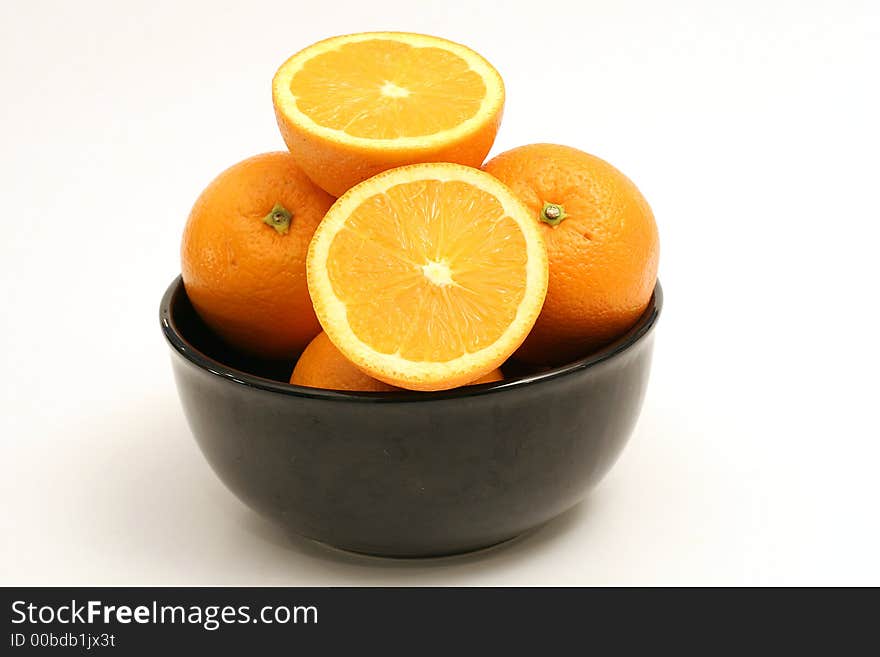 Shot of a bowl of oranges on white