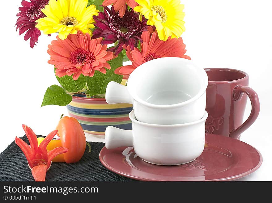 A bright bowl of festive spring flowers enhance this table set with plate,bowls ,cup,colorful peppers and a chili pepper flower. A bright bowl of festive spring flowers enhance this table set with plate,bowls ,cup,colorful peppers and a chili pepper flower.