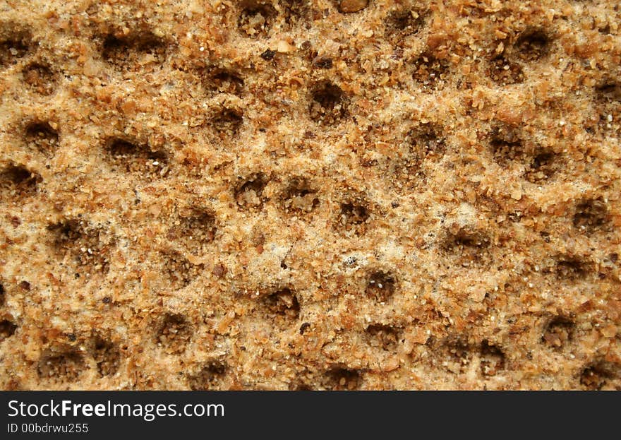 Roughly textured surface of a rye cracker. Roughly textured surface of a rye cracker.