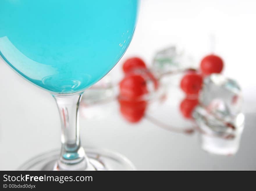 Group of four  cherries, ice cubes and blue drink. Group of four  cherries, ice cubes and blue drink