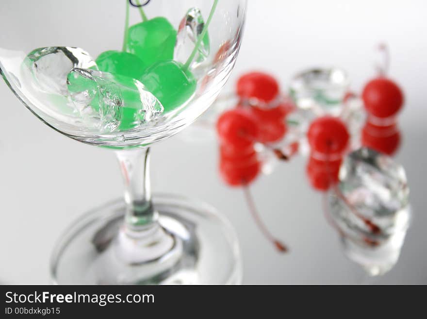 Group of green and red cherries with ice cubes