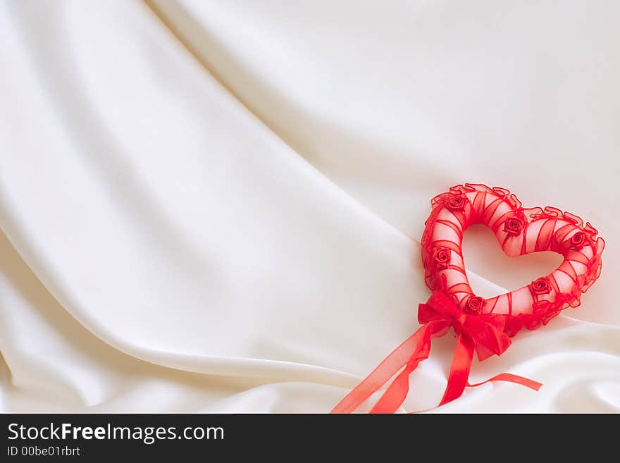 Red heart on a silk background. Red heart on a silk background