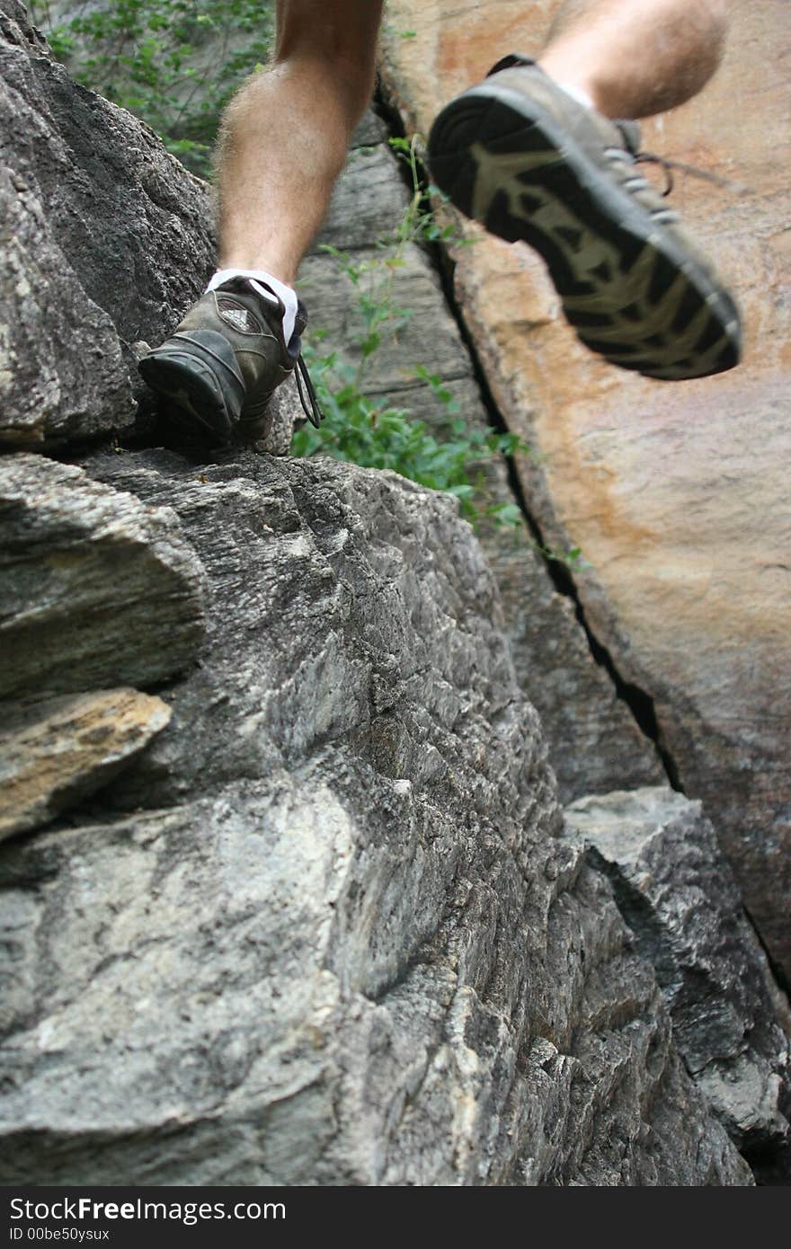 AN IMAGE OF SOMEONE TRYING TO ASCEND UP A ROCK FACE. AN IMAGE OF SOMEONE TRYING TO ASCEND UP A ROCK FACE.