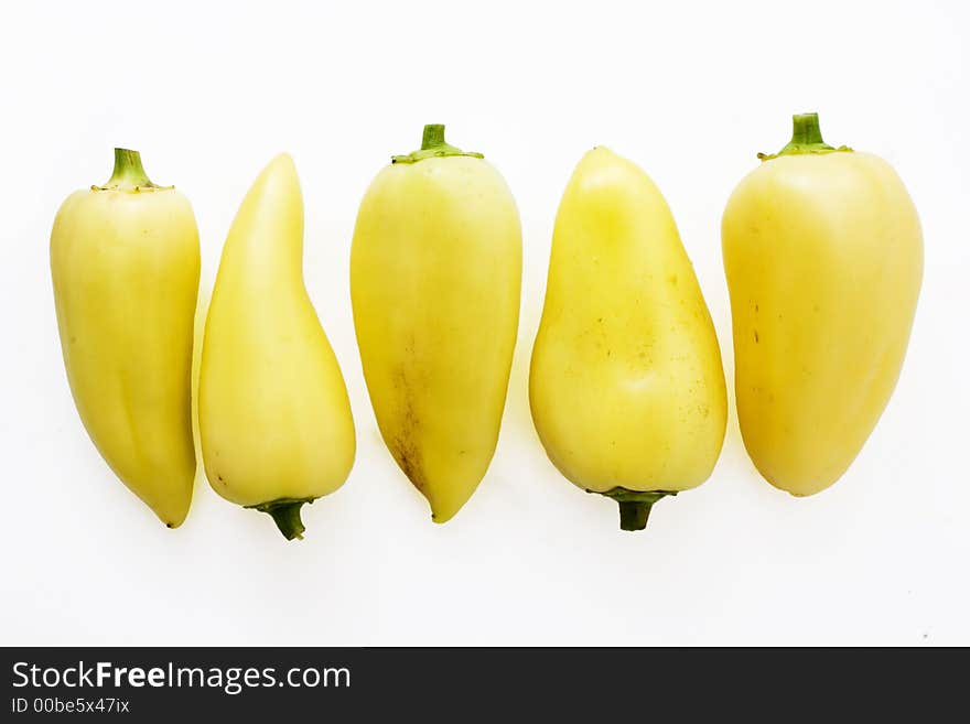 Group of yellow bellpeppers  over  white