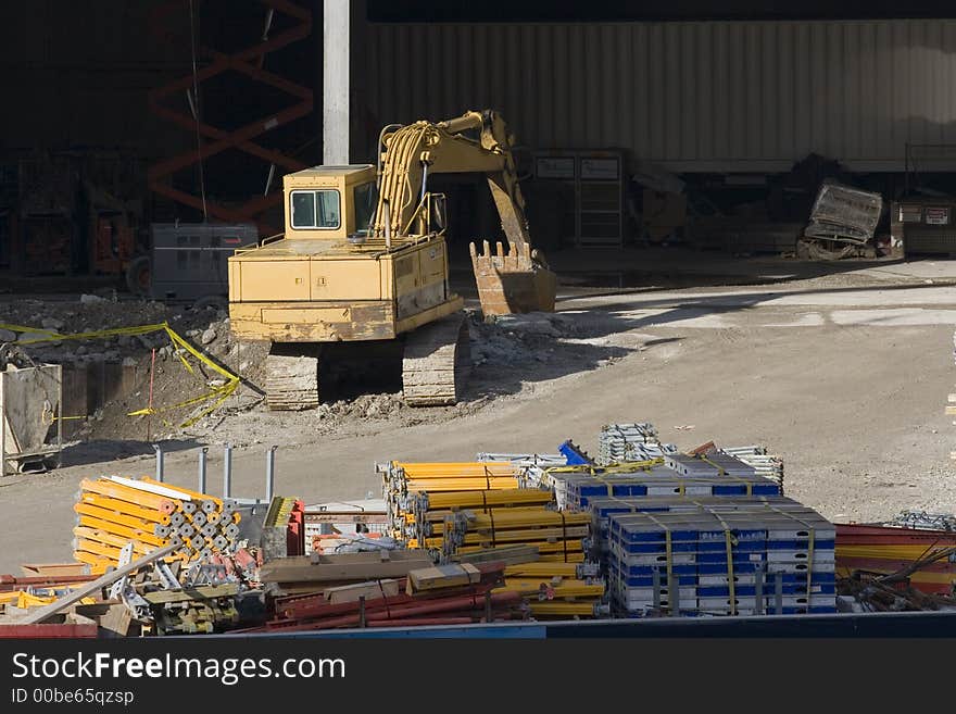 Yellow excavator on a construction site. Yellow excavator on a construction site