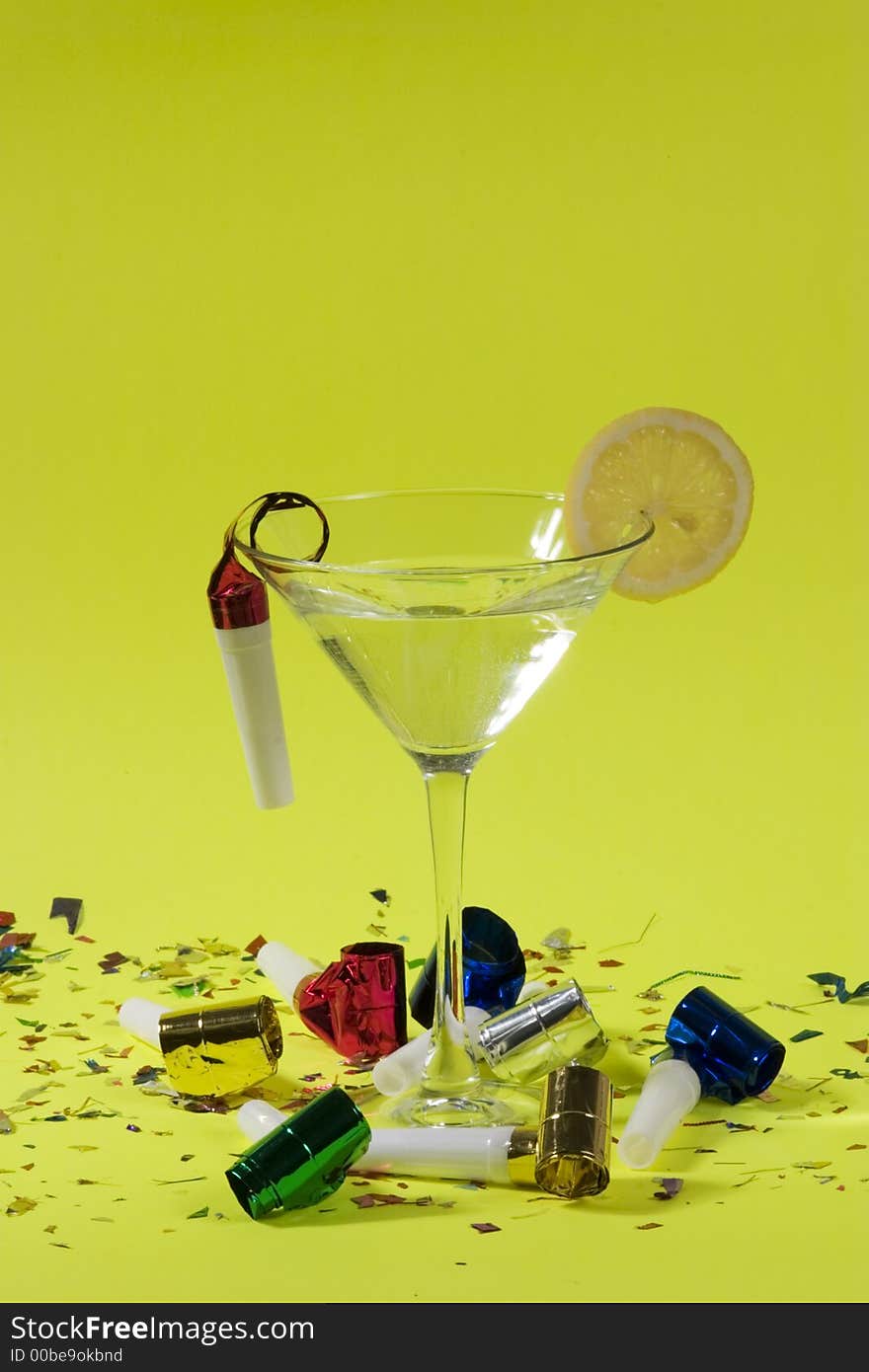 Martini drink, fancy shoe and party blowers over green background. Martini drink, fancy shoe and party blowers over green background