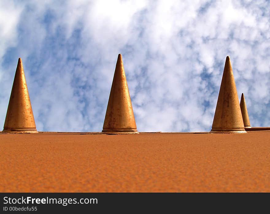 Metal cones against a blue cloudy sky