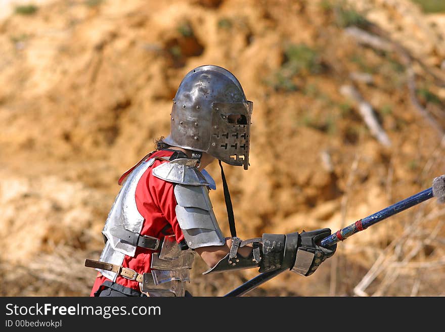 A knight prepares to do battle at a rennaissance fair. A knight prepares to do battle at a rennaissance fair.