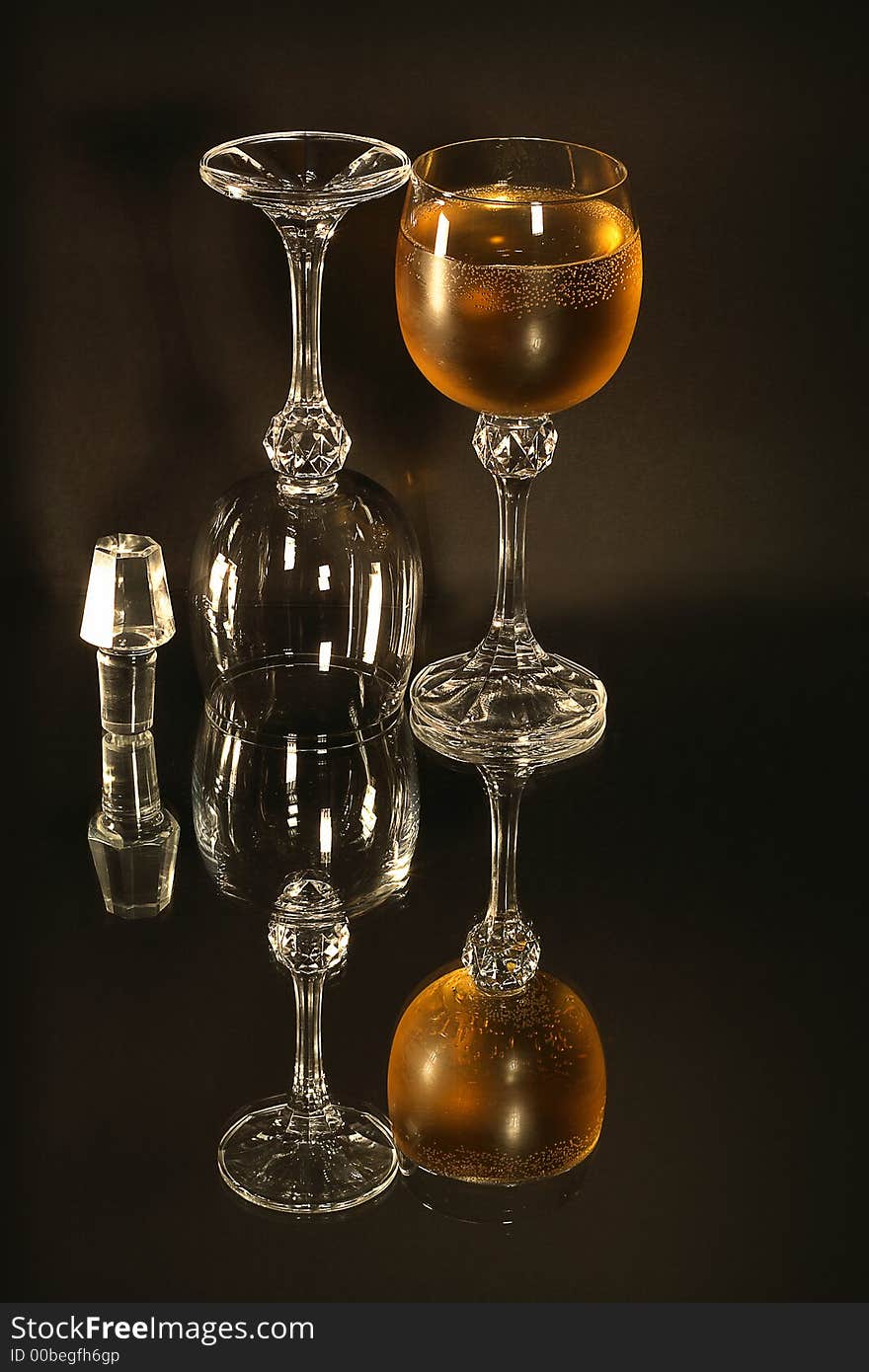 Simple glass and wine still composition with mirror and black background. Two 300 Watt halogen lamps. Simple glass and wine still composition with mirror and black background. Two 300 Watt halogen lamps