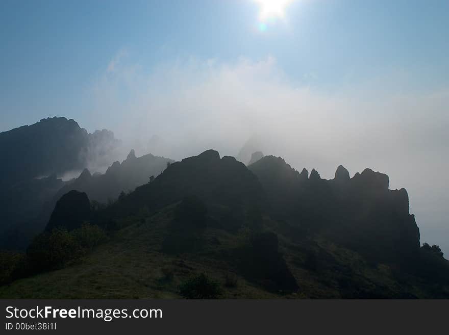 The sun lighting up the mountain ridge and a valley