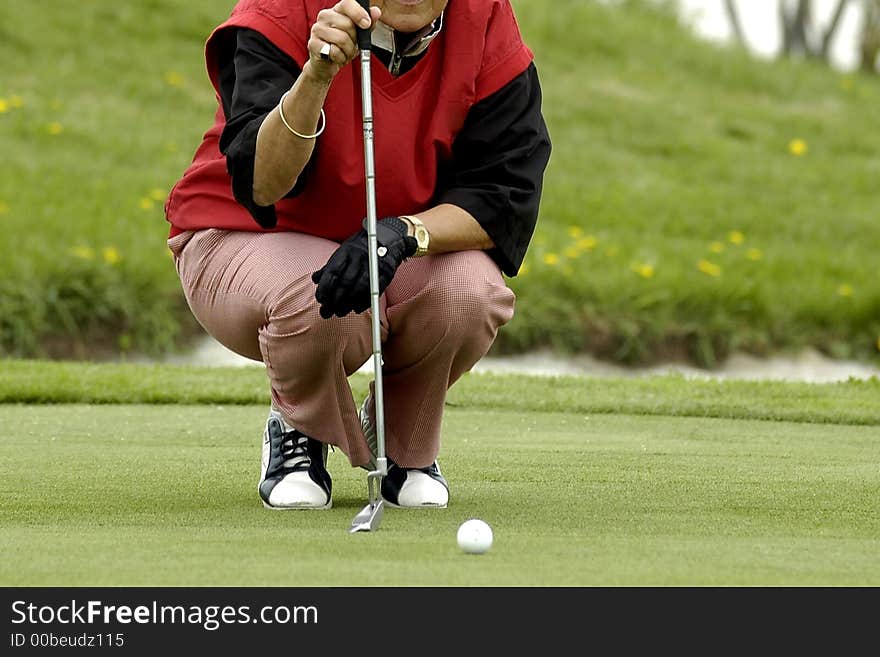 The woman the golfer to prepare for impact of a ball. The woman the golfer to prepare for impact of a ball