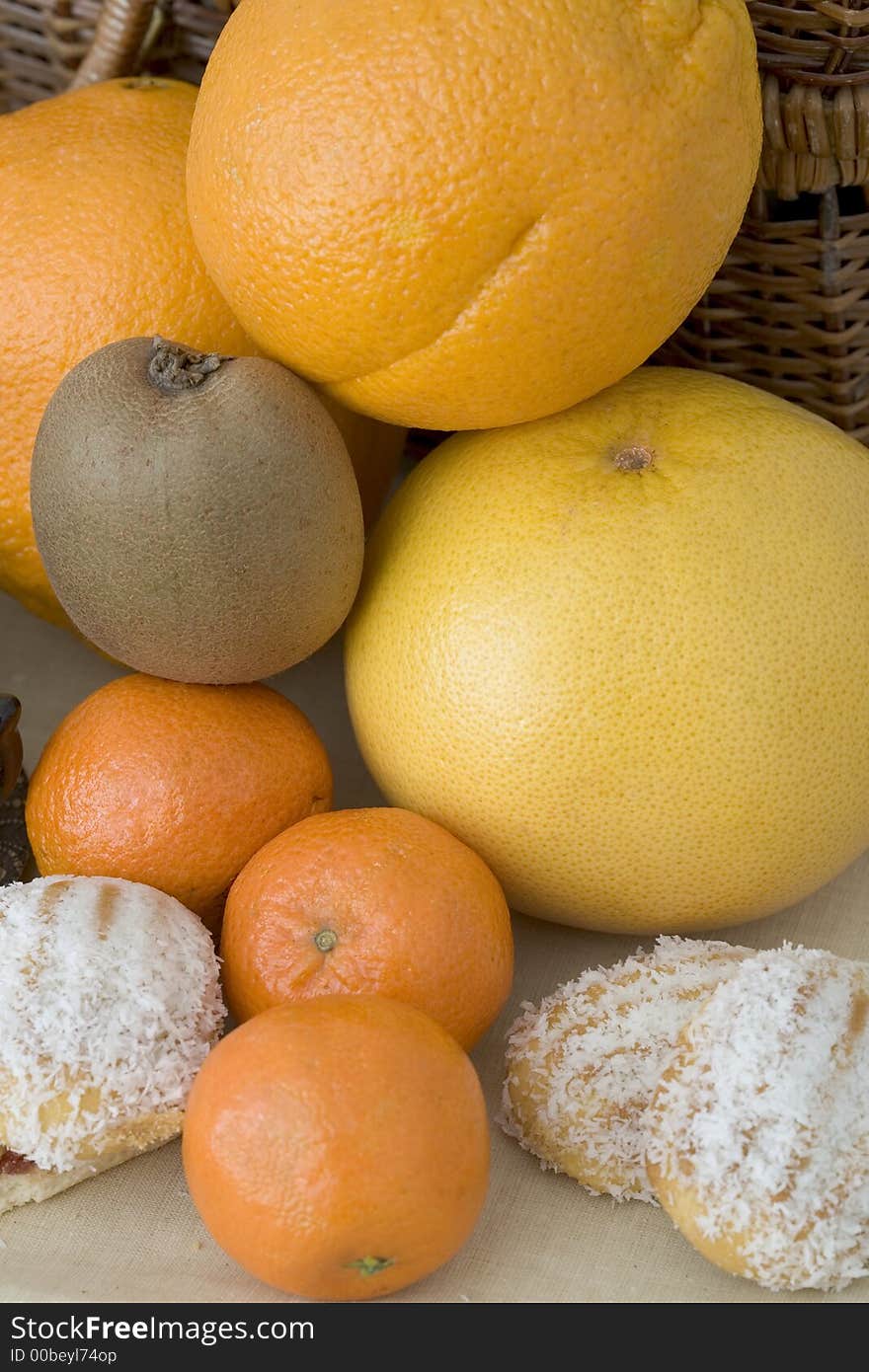 Delicious lunch-set of kiwi, oranges ans grapefruit surraounded by coconut pastry